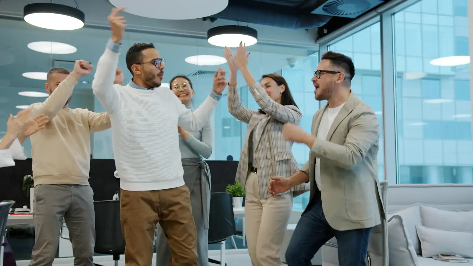 Diverse group of colleagues celebrating success in an office