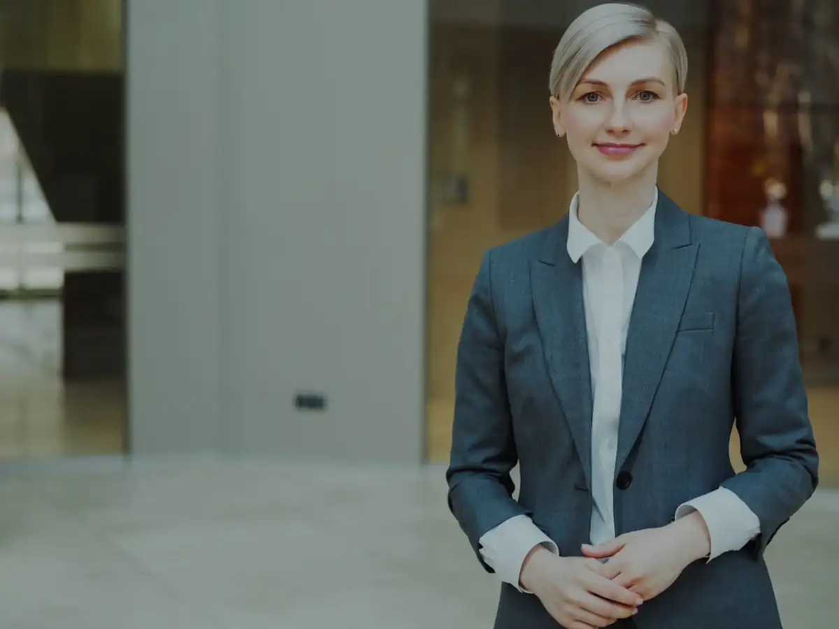 Professional businesswoman in a suit smiling confidently