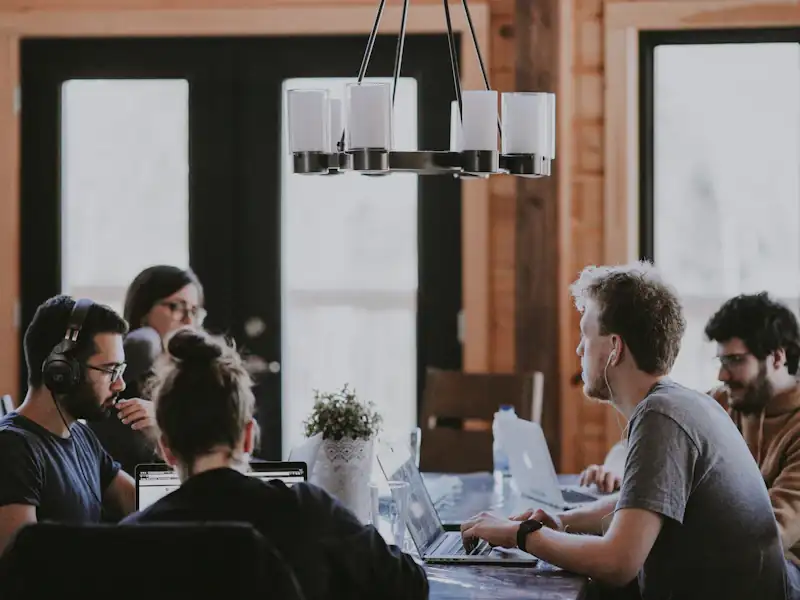 Agency team working together at a shared table in an office