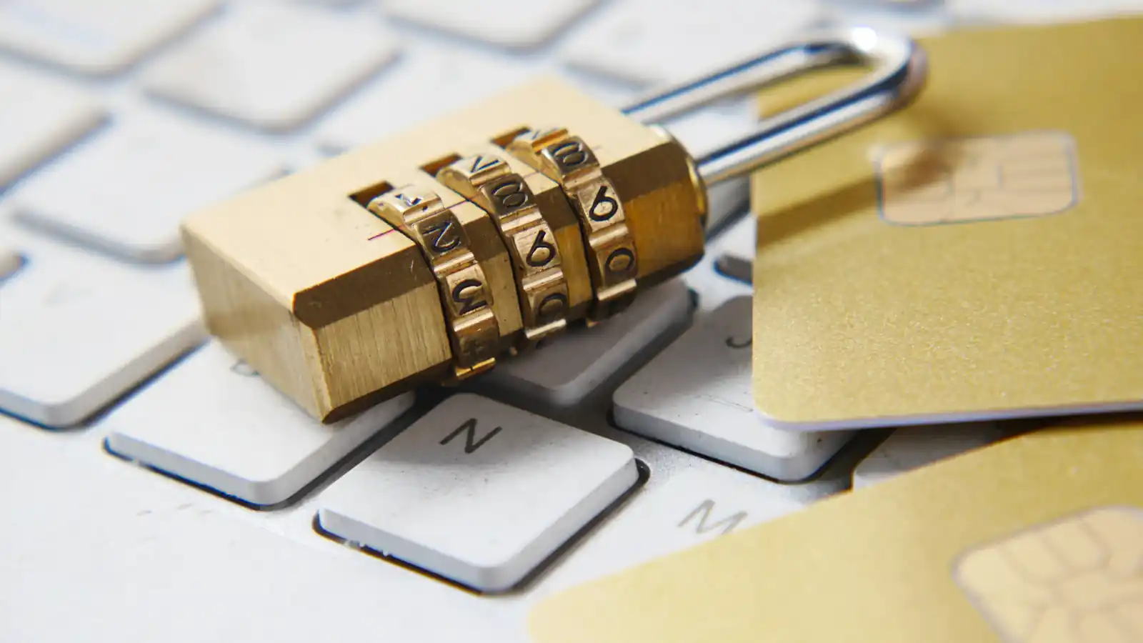 Golden padlock resting on a keyboard representing privacy