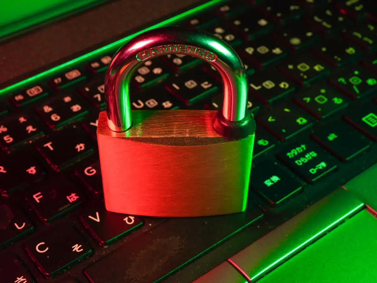 Red padlock on a black computer keyboard representing data security