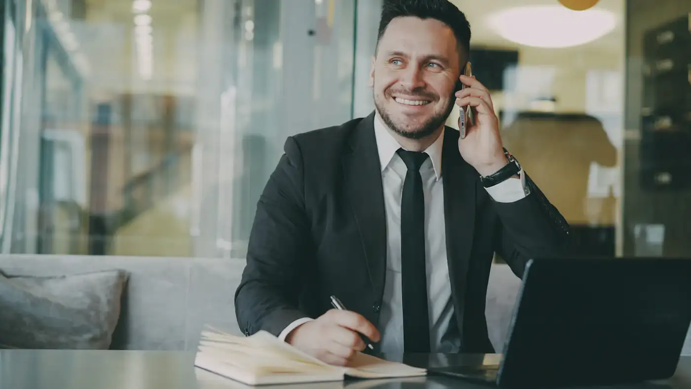 Recruitment consultant on a client call at a desk with a laptop