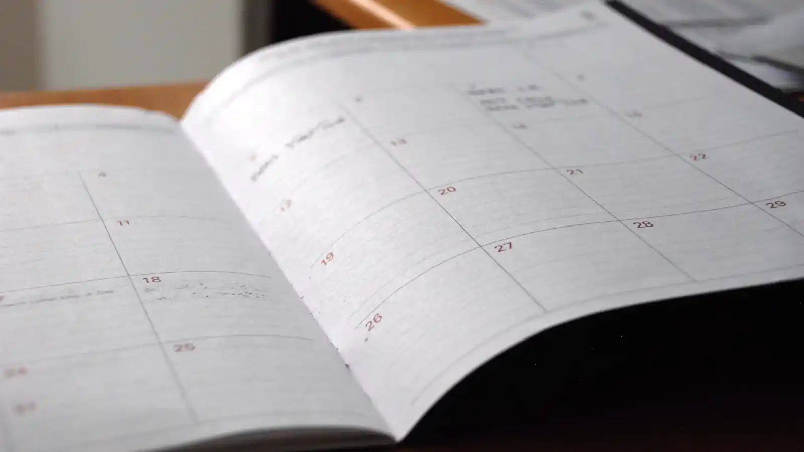 Open monthly planner on a wooden desk