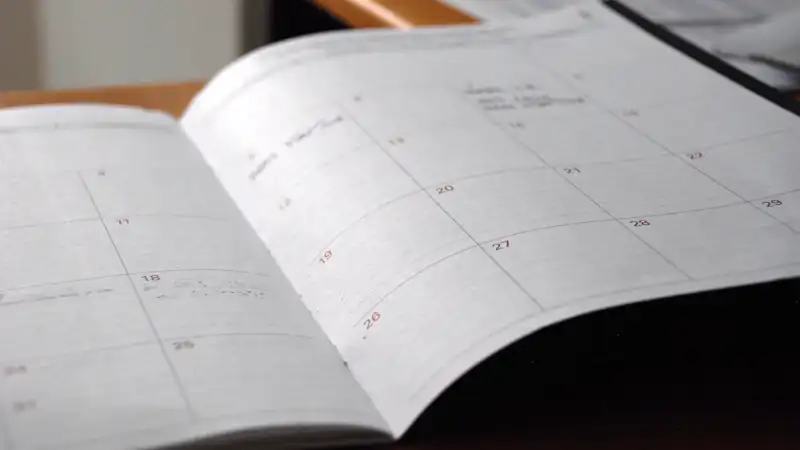 Open monthly planner on a wooden desk