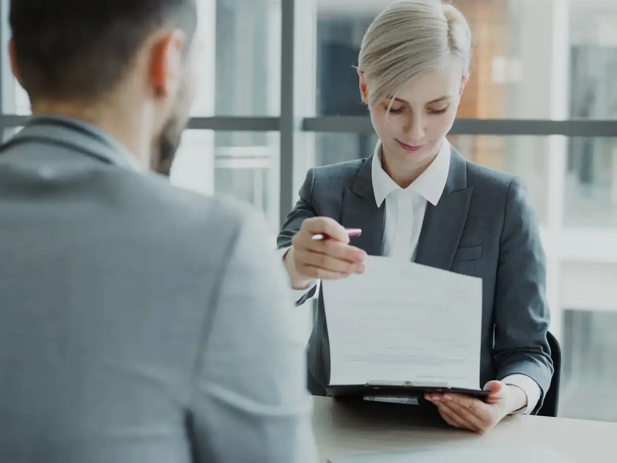Recruiter showing a formatted CV to a hiring manager